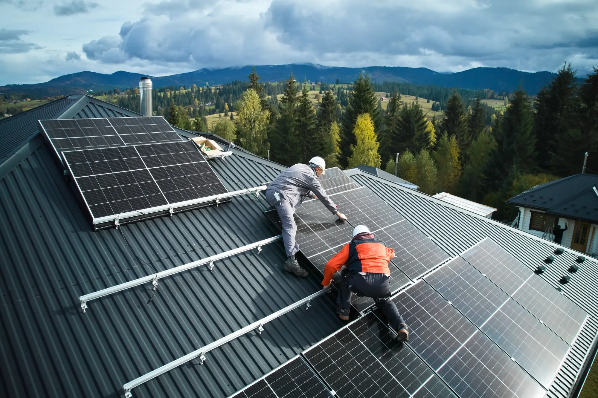 solar technicians on a roof installig solar panels